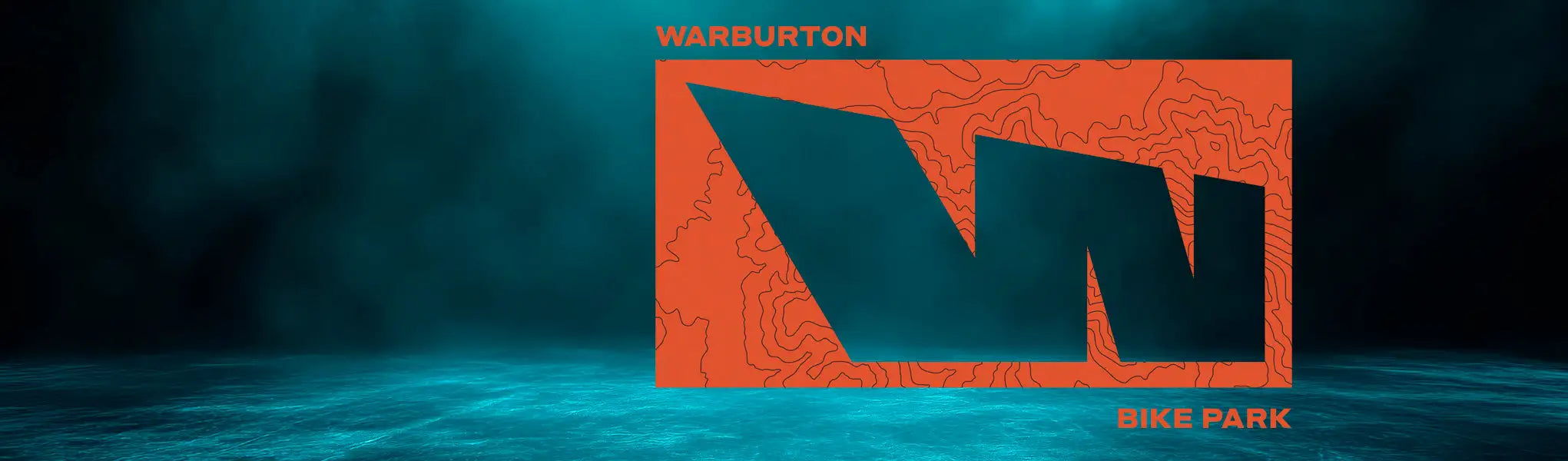 Warburton bike park logo featuring a bold black stylized ’w’ on an orange background with topographic line details.