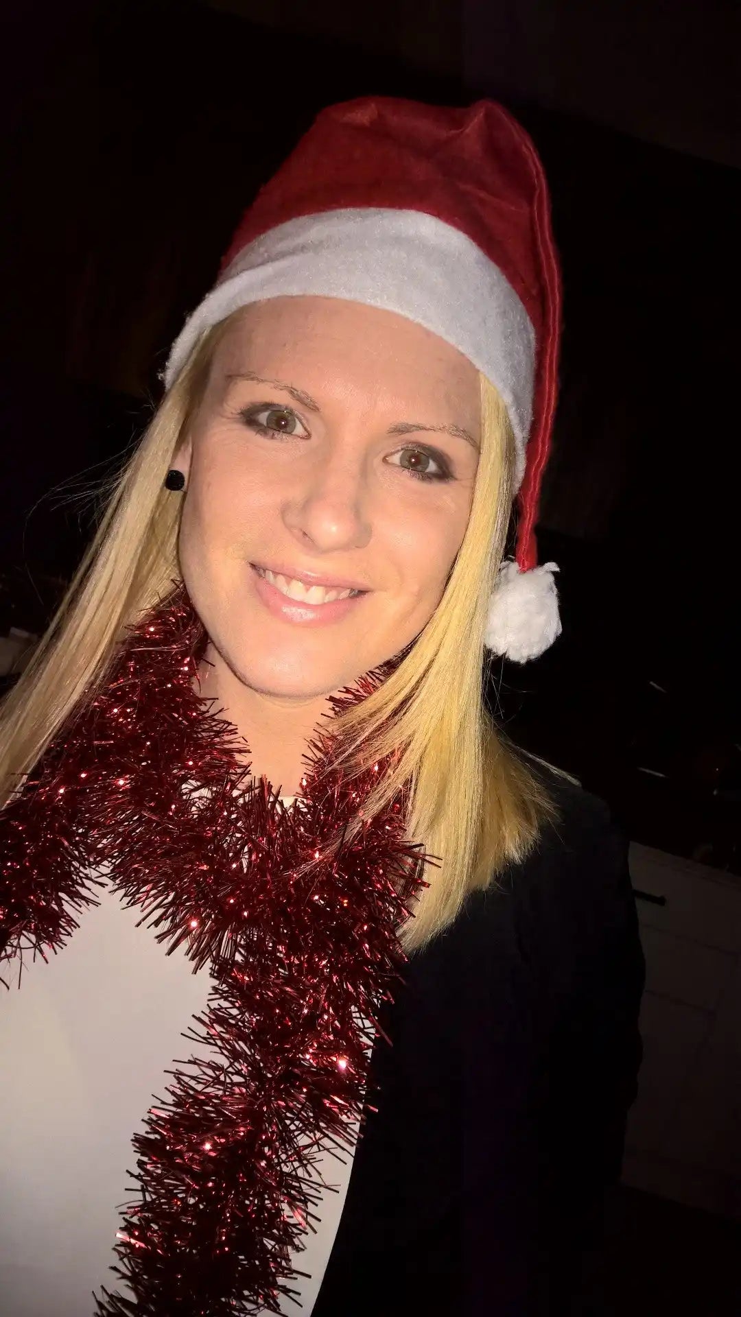 Smiling woman in Christmas attire.