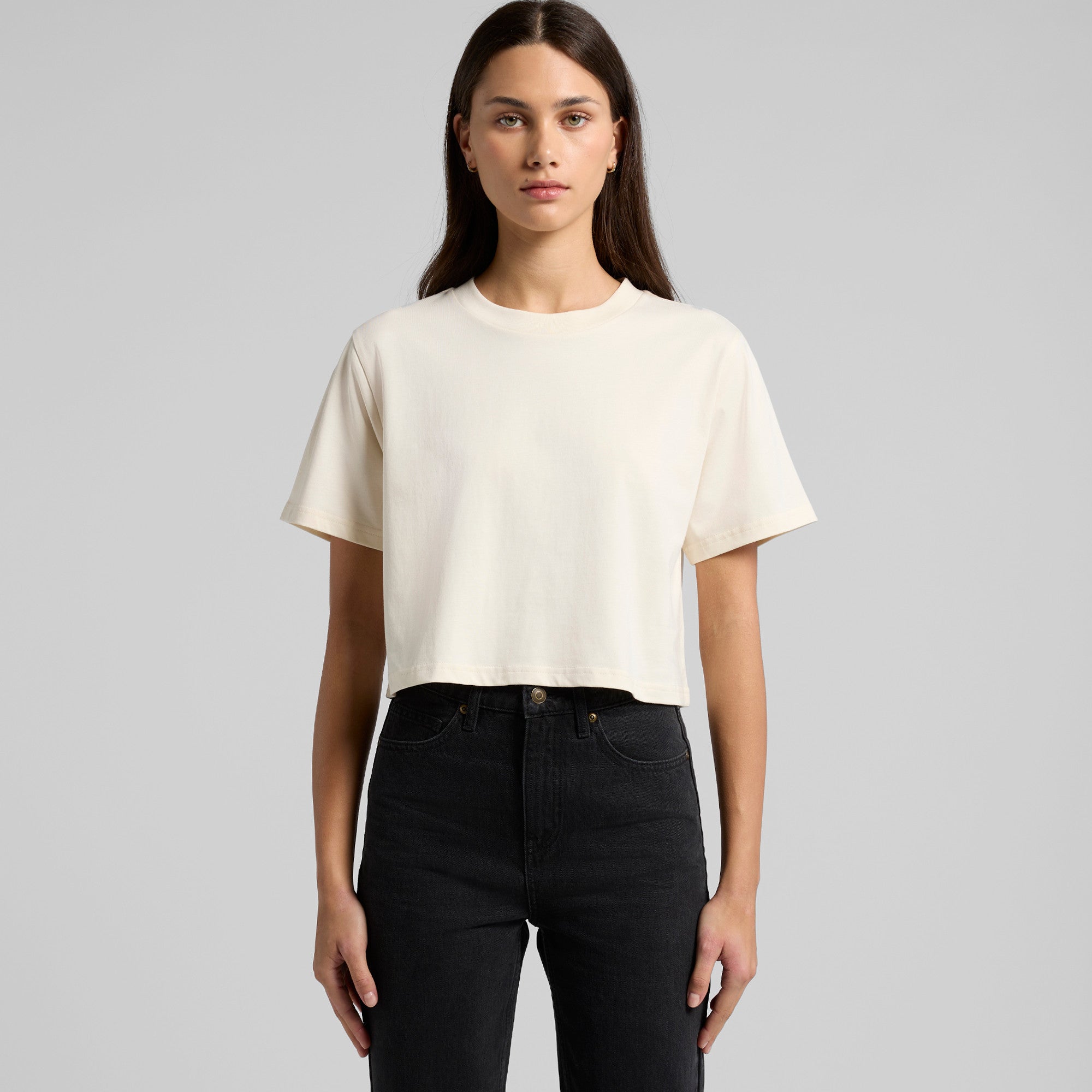 Cream-colored cropped t-shirt with short sleeves and a relaxed fit, likely made of cotton or polyester blend.
