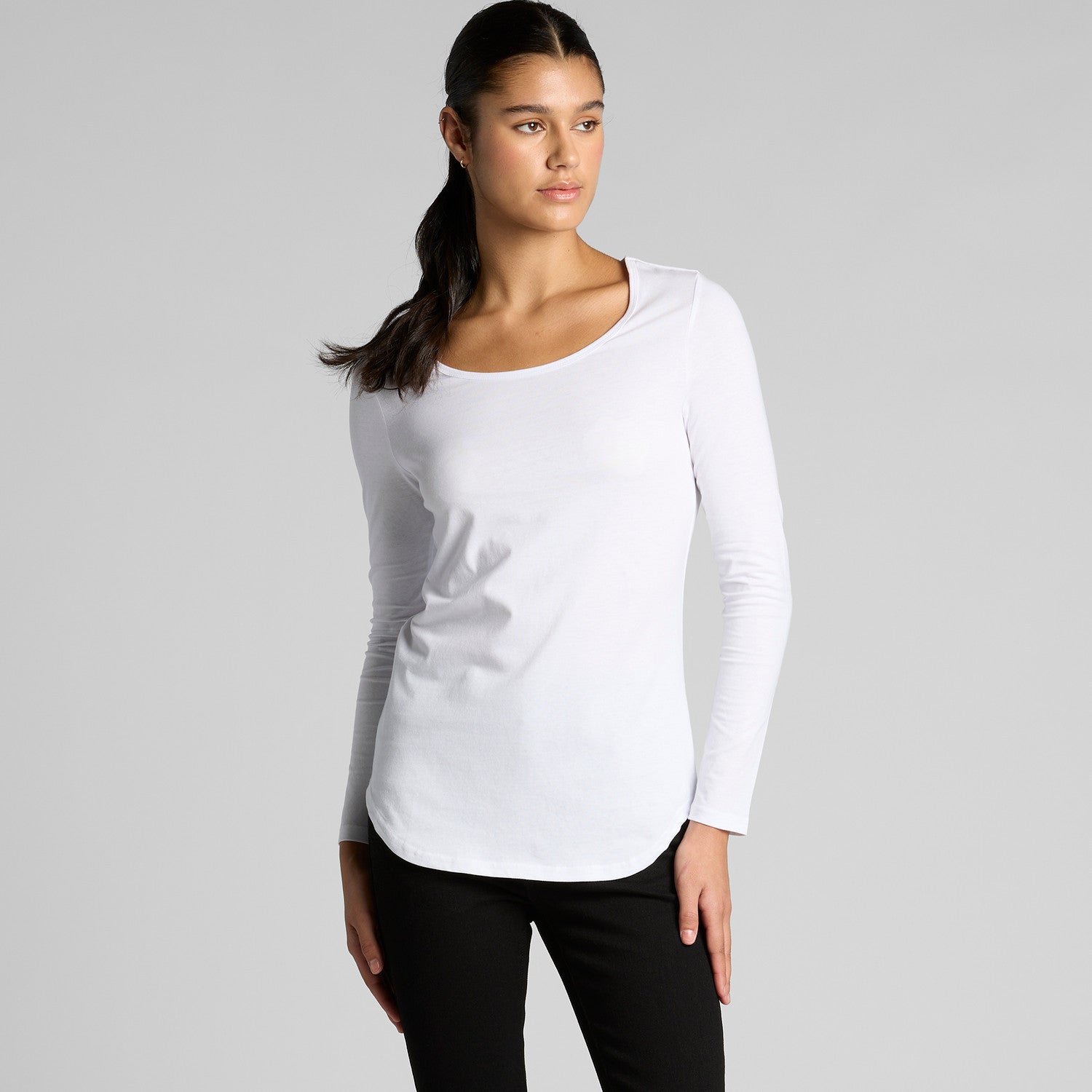 White long-sleeved scoop neck top with black leggings.