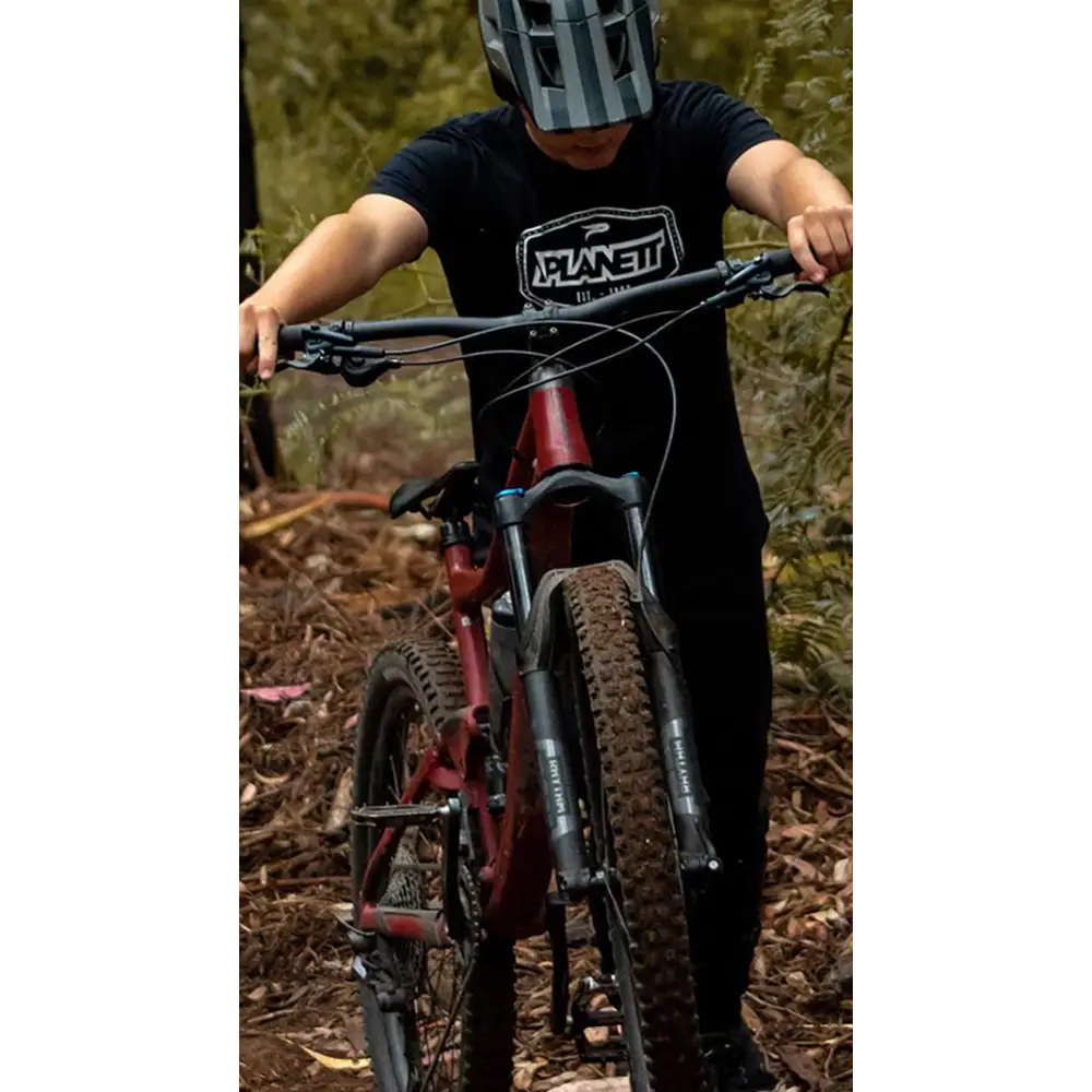 Mountain biker with muddy tires.