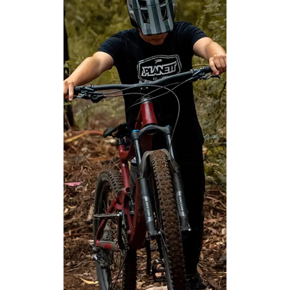 Mountain biker with muddy tires.