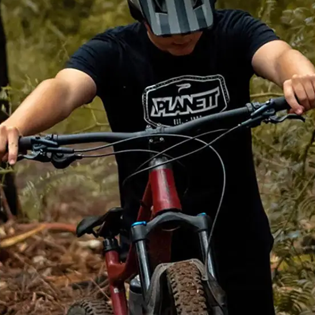 A person riding a mountain bike on a dirt trail.